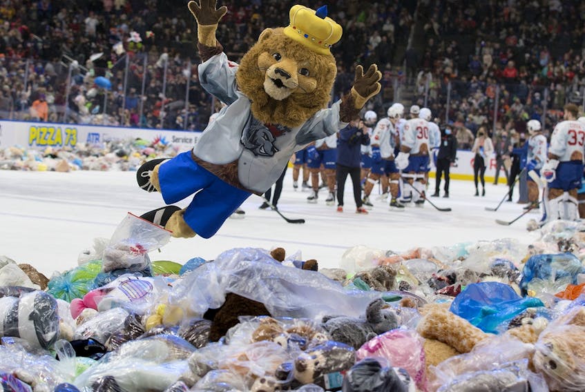 The Edmonton Oil Kings mascot, Louie the Lion, jumps into a pile of a teddy bears during the Oil Kings' 14th annual Teddy Bear Toss in Edmonton on Saturday Dec. 4, 2021.
