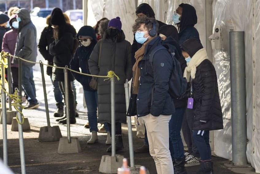 People line up at a COVID-19 testing site in Montreal on Wednesday, December 1, 2021.