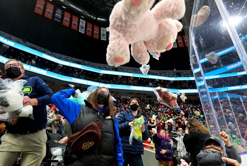 Fans throw teddy bears onto the ice following a first period goal by the newest member of teh Edmonton Oil Kings, Graydon Gotaas, during the 14th annual Teddy Bear Toss in Edmonton on Saturday Dec. 4, 2021.
