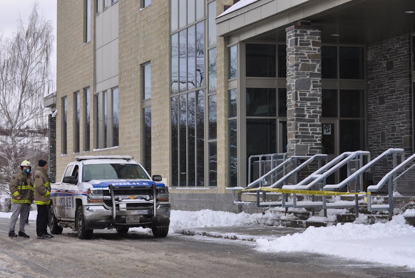 Members of the Corner Brook Fire Department talk with RNC officers outside the Danny Williams Building on Mount Bernard Avenue on Monday, Dec. 6. The building was closed because of a bomb threat.