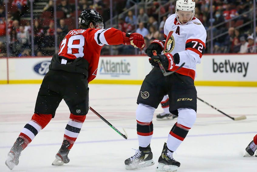 Senators defenceman Thomas Chabot (72) skates the puck past New Jersey Devils defenseman Damon Severson (28) during the first period at Prudential Center on Monday night. 
