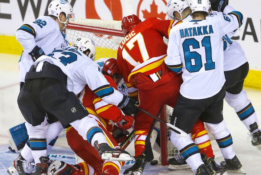 The Calgary Flames’ Milan Lucic scores on San Jose Sharks goaltender Adin Hill at the Scotiabank Saddledome in Calgary on Tuesday, Nov. 9, 2021. 