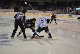 The Charlottetown Islanders’ Patrick Guay takes a faceoff against the Saint John Sea Dogs’ Charles Savoie, 9, as linesman Mat Hicks drops the puck in a Quebec Major Junior Hockey League regular-season game at Eastlink Centre earlier this season. Guay has recorded 21 points in the last eight games for the Islanders, who are back in action on home ice against Drummondville on Dec. 8 at 7 p.m.