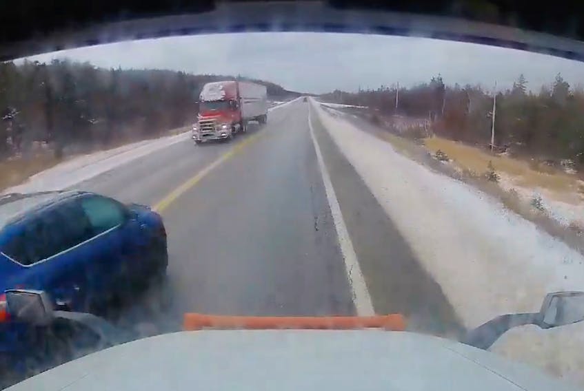 A screenshot from a video Tony Power recorded on the dash cam of his tractor trailer shows when an SUV crosses in front of him on a double yellow line with another tractor trailer approaching. The SUV managed to get in front of Power just before the two trucks met.