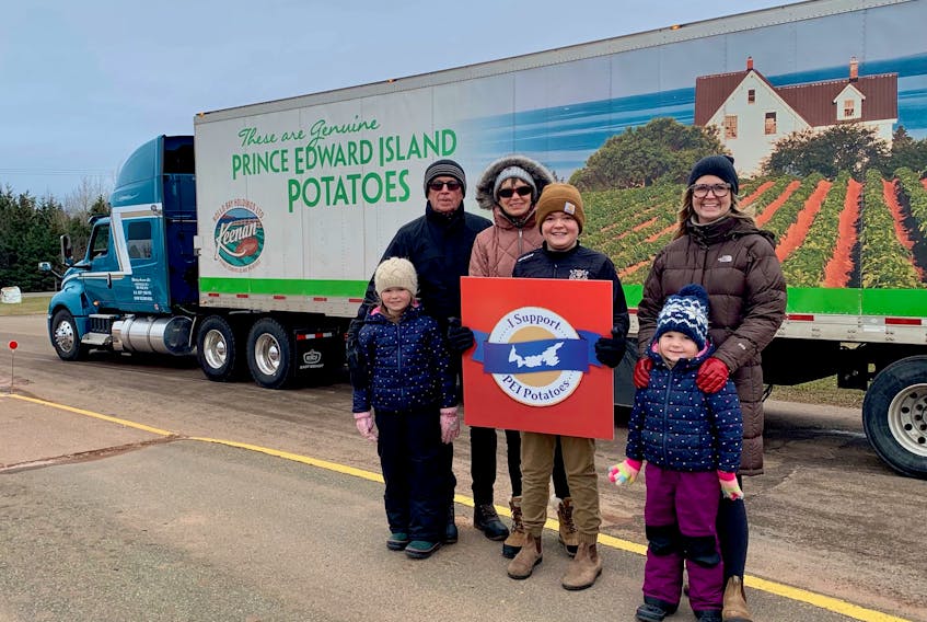 The MacKay family of Prince Edward Island, from left, Everleigh, Harleigh, Susan, Elliott, Robyn and Thatcher MacKay, were on hand to help pack and send off the P.E.I. potato truck from Charlottetown to Ottawa on Monday, Dec. 6.