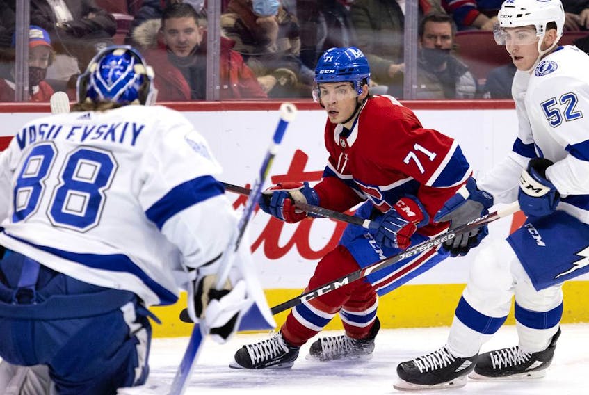 Montreal Canadiens centre Jake Evans (71) tries to get a shot off against Tampa Bay Lightning goaltender Andrei Vasilevskiy (88) as Lightning defenceman Cal Foote (52) pressures him during first-period NHL action in Montreal, on Tuesday, December 7, 2021.