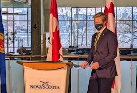 Nova Scotia Premier Tim Houston steps up to the podium Wednesday, Dec. 8, 2021, in Dartmouth to announce $57 million in funding for long-term-care support programs. The news conference was held at the Ivany Campus of the Nova Scotia Community College.