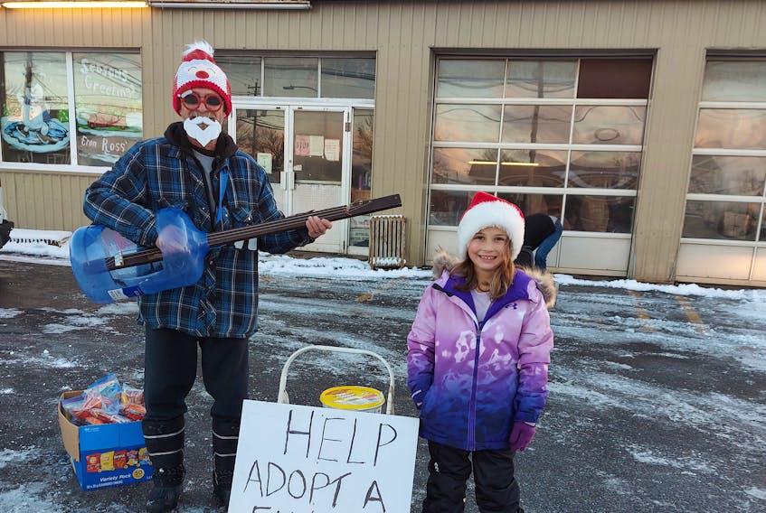 Bucky Walzake, who along with his granddaughter Peyton, raised $2,005.15 last year for Combined Christmas Giving by playing music and passing out treats. CONTRIBUTED