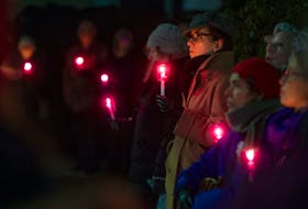 People attend a vigil commemorating the Dec. 3 National Day of Remembrance and Action on Violence against Women remembering the 14 women murdered at Ecole Polytechnique, in Montreal in 1989. — SaltWireNetwork file photo