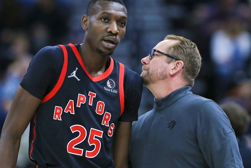 Toronto Raptors forward Chris Boucher (left) and head coach Nick Nurse speak during a game early this month.