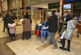 Former NATO employees and their family members arrived in Halifax Wednesday night from a third country after leaving Afghanistan. They are pictured at the Halifax Stanfield International Airport on December 8, 2021.