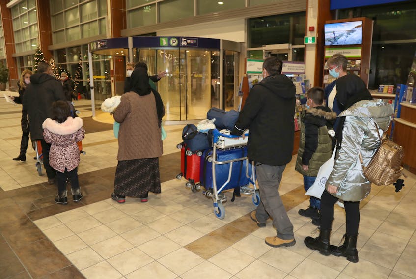 Former NATO employees and their family members arrived in Halifax Wednesday night from a third country after leaving Afghanistan. They are pictured at the Halifax Stanfield International Airport on December 8, 2021.