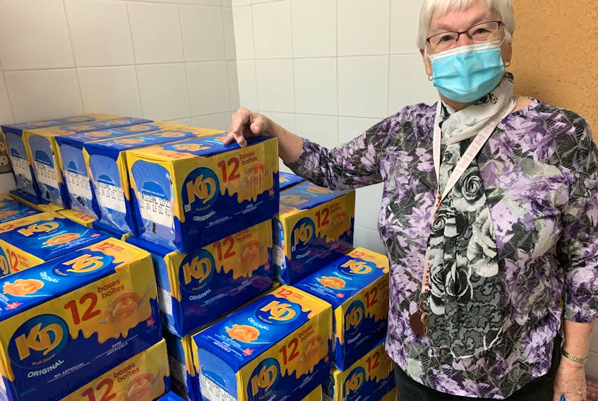 Doris Walton of Amherst’s After the School Bell Program sorts cases of Kraft Dinner it purchased for the 110 food bags it gives to students at nine Cumberland County schools every week. Darrell Cole – SaltWire Network