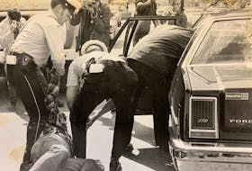 Bob Wakeham is dragged away by Royal Newfoundland Constabulary officers 40 years ago. Wakeham was among the Evening Telegram employees on strike at the time. The building fronted on Duckworth Street and backed on Water Street.