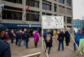 Supporters of Save Owls Head provincial park take part in a rally outside the law courts building in Halifax on Wednesday, March 31, 2021.