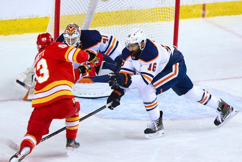Calgary Flames forward Sam Bennett gets a shot on Edmonton Oilers goaltender Mike Smith and as Oilers defenceman Jujhar Khaira reaches in during NHL action at the Scotiabank Saddledome in Calgary on Saturday, April 10, 2021. 

Gavin Young/Postmedia