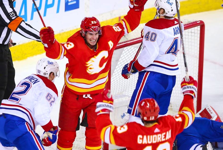Calgary Flames forward Sean Monahan celebrates with Johnny Gaudreau after scoring on Montreal Canadiens goaltender Carey Price at the Saddledome in Calgary on Saturday, March 13, 2021. 