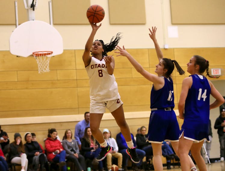 Citadel's Kyasiah Derry drives to the hoop past Lockview defenders Emma Foye and Ellie Lancaster during a metro high school basketball league game. The Phoenix will face the Dartmouth Spartans in the Capital Region championship on Tuesday. - Tim Krochak / The Chronicle Herald