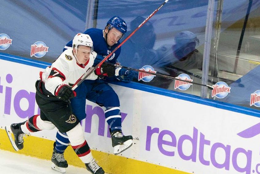 Leafs defenceman Morgan Rielly (right) battles along the boards with Ottawa Senators winger Brady Tkachuk at Scotiabank Arena last night. USA TODAY SPORTS
