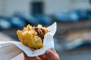  An arancino, the typical Sicilian street food made of saffron rice and meat in a fried breaded ball