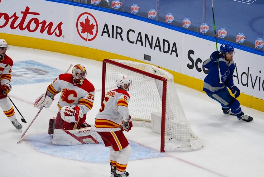Toronto Maple Leafs' William Nylander celebrates scoring the game-winning goal on Calgary Flames goaltender David Rittich as defenceman Mark Giordano looks on during overtime at Scotiabank Arena on Wednesday, Feb. 24, 2021. 