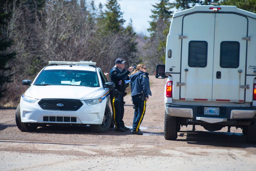 Police vehicles pass through an RCMP checkpoint on Portapique Beach Road on Wednesday, April 22, 2020.
Ryan Taplin - The Chronicle Herald