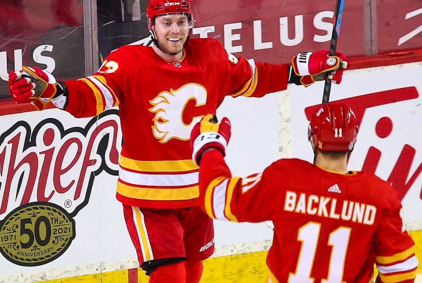  The Calgary Flames’ Sam Bennett celebrates with Mikael Backlund after scoring against the Winnipeg Jets at the Saddledome in Calgary on Saturday, March 27, 2021.