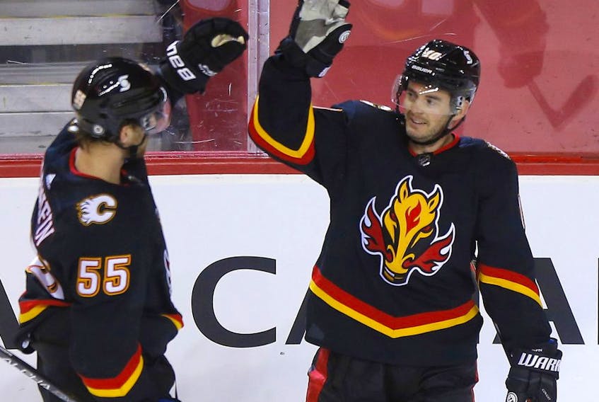  The Calgary Flames’ Derek Ryan (right) celebrates his goal, with Noah Hanifin, against the Ottawa Senators at the Saddledome in Calgary on Thursday, March 4, 2021.