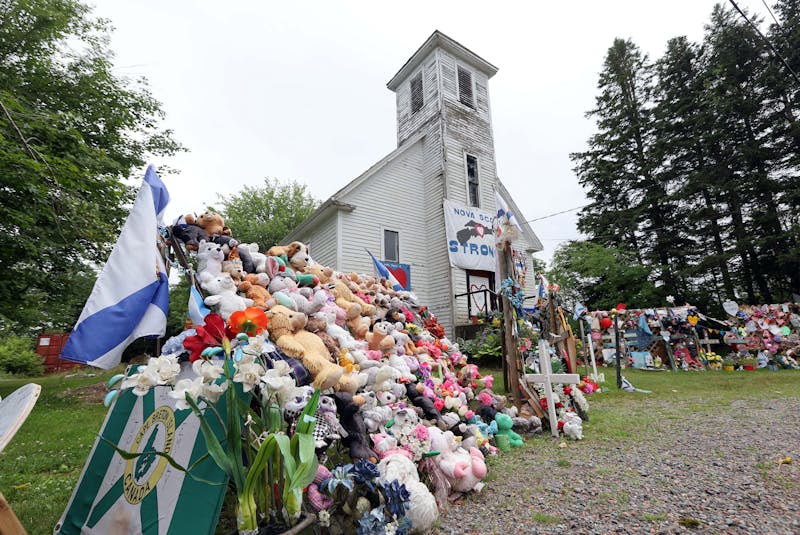 Items of condolence overflow on the steps and yard in front of the old Portapique Church on July 23, 2020. The items have since been removed from in front of the church. - Eric Wynne / File