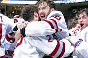 Jake Gaudet celebrates with teammate Marc Del Gaizo (No. 2) of the Massachusetts Minutemen after a 5-0 victory over the St. Cloud St. Huskies at PPG Paints Arena on April 10, 2021, in Pittsburgh.