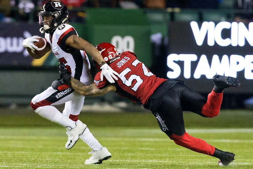  The Calgary Stampeders’ Riley Jones tackles the Ottawa Redblacks’ Diontae Spencer (85) during the Grey Cup at Commonwealth Stadium in Edmonton on Sunday, Nov. 25, 2018.