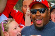 Nik Lewis poses for a photo with Nik Lewis Nation fans during a tailgate party before a game between the Calgary Stampeders and the Montreal Alouettes,the CFL receptions leader signed a one-day contract with Stampeders before announcing his retirement last Friday. Al Charest/Postmedia