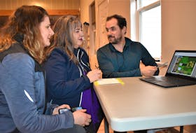 Erin MacKinnon (left), Alana Hirtle and Andrew MacDonald of the Rotary Care Committee go over plans for major improvements to the Portapique Community Hall. The work and hall enhancements are seen as a way for the community to heal following the mass shootings last April.