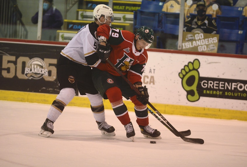 Halifax Mooseheads defenceman Jason Horvath, right, tries to spin away from the forecheck of Braeden Virtue of the Charlottetown Islanders Tuesday in Charlottetown. - Jason Malloy • The Guardian