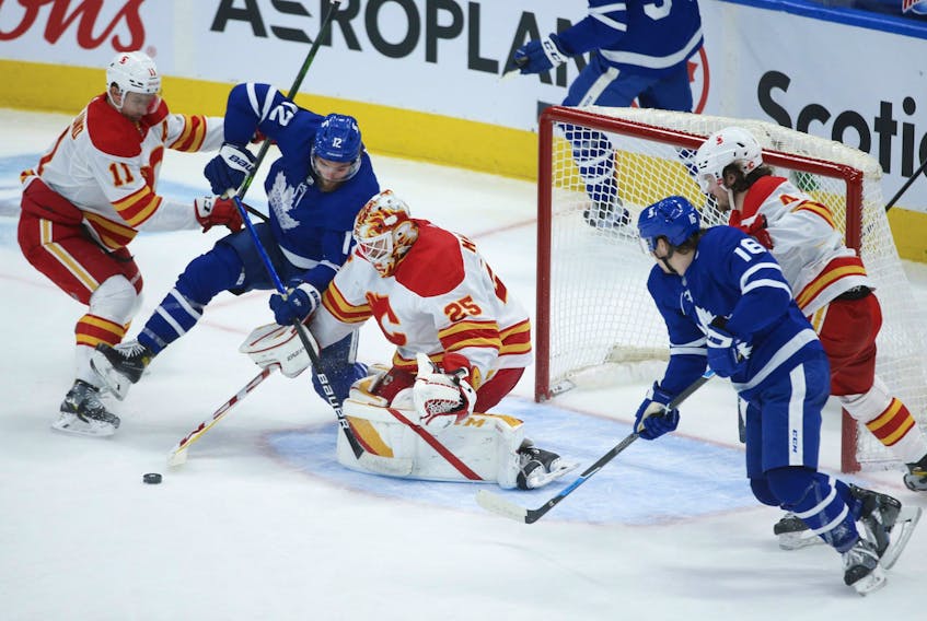 Calgary Flames goalie Jacob Markstrom makes a save on Maple Leafs' Alex Galchenyuk during the second period in Toronto on Tuesday, April 13, 2021. 