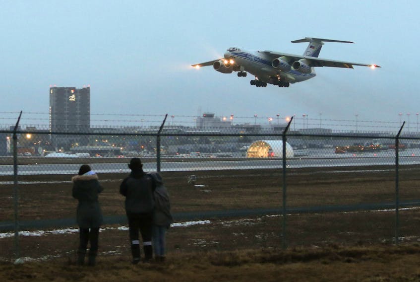 Planespotters look on as a Volga-Dnepr Group Ilyushin Il-76, bound for the Barbados lifts off from at Halifax Stanfield Sunday January 17, 2020. The aircraft is often used to move oversize, unique and heavy air cargo.