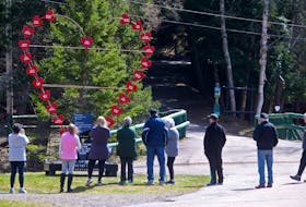 FOR MASS SHOOTING ANNIVERSARY COVERAGE:
People stop to look at the large heart memorial, made with names of those killed in the Nova Scotia mass shooting and placed at the trail head in Victoria Park in Truro, NS Wednesday April 14, 2021.

TIM KROCHAK PHOTO