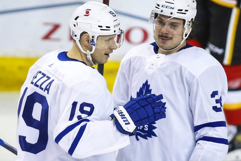 Toronto Maple Leafs' Auston Matthews, right, celebrates his goal with teammate Jason Spezza during third period NHL hockey action against the Calgary Flames in Calgary, Sunday, Jan. 24, 2021. 