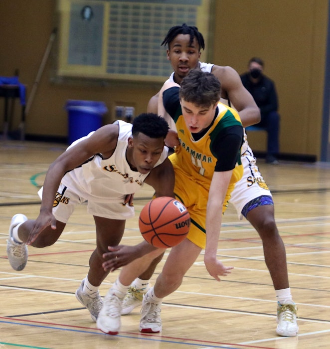 Dartmouth's Naijuan David and Kyle Munro of Halifax Grammar School battle for control of a loose ball during the first quarter of the Capital Region championship at Dartmouth High. - Eric Wynne / The Chronicle Herald - Eric Wynne