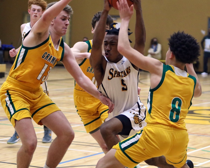 Dartmouth's Kyree Thompson splits the Halifax Grammar School defence of Olin Bailly, Gabe Davignon and Kaymon Grouse on Wednesday. Thompson led all scorers with 28 points in the Capital Region championship. - Eric Wynne / The Chronicle Herald - Eric Wynne