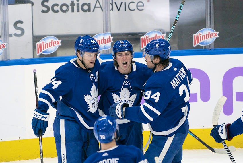  Maple Leafs’ Mitchell Marner (centre) celebrates with Auston Matthews (right) after scoring a goal against the Ottawa Senators during the second period at Scotiabank Arena on Saturday, April 10, 2021.
