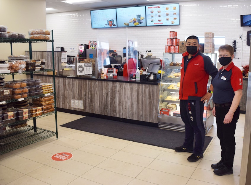 Richard He and Barb Smith stand by the Robins Donuts located in the new Petro-Canada gas station off of the Stellarton rotary. - Adam MacInnis