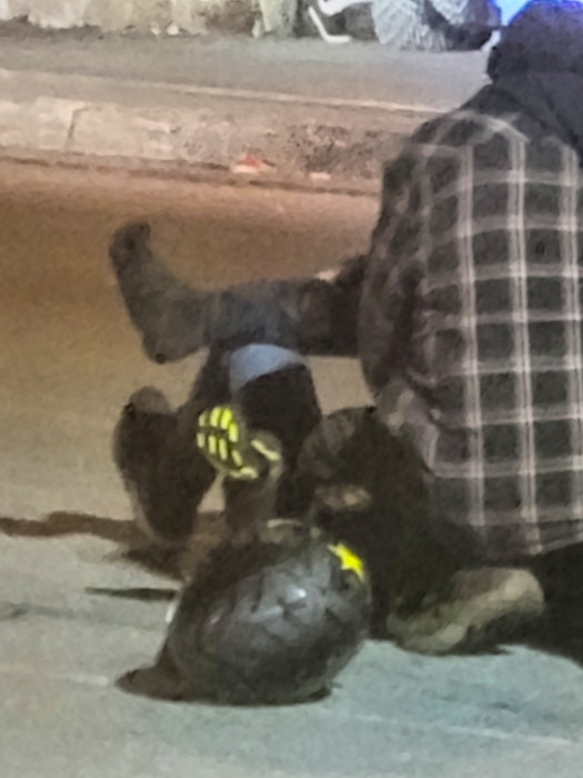 An injured teenager receiving assistance after a collision between a dirt bike and motor vehicle on Victoria Road in Whitney Pier, Wednesday night. The two teens on the bike were transported to hospital with non life-threatening injuries. Contributed/Royce Madinsky