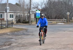 Frank Graham crossing busy Willow Street to continue on the Cobequid Trail.