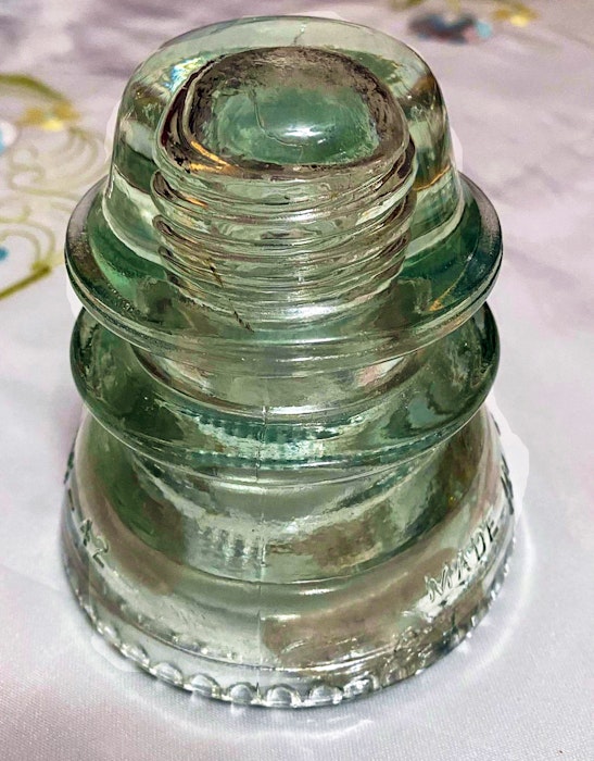 A glass insulator that was used many years ago to connect electrical wires to utility poles along the first bridge at River Ryan. Contributed - Contributed