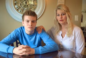 Yvonne MacKenzie, with her son, Dawson, 15, who is autistic, at their home in Dominion. MacKenzie says her son has endured nothing but horrific bullying at Glace Bay High School and last week the bullying escalated. Sharon Montgomery-Dupe/Cape Breton Post