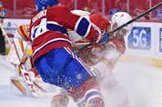 MONTREAL, QC - APRIL 14:  Nick Suzuki #14 of the Montreal Canadiens and Mark Giordano #5 of the Calgary Flames chase the puck during the second period at the Bell Centre on April 14, 2021 in Montreal, Canada.