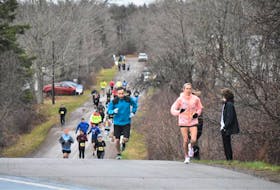 Marathon runners in the Nova Scotia Remembers Memorial Race emerge from the Portapique Loop onto Highway 2 as they make their way to Truro's Victoria Park on Sunday.