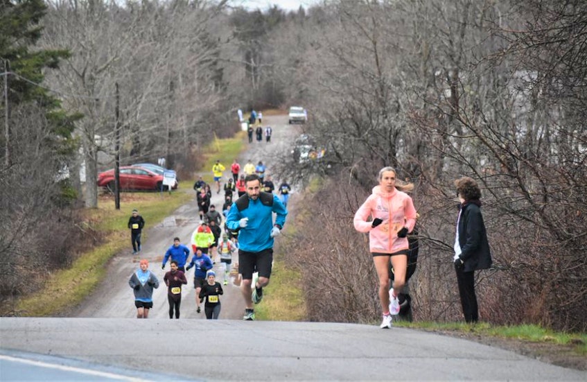 Marathon runners in the Nova Scotia Remembers Memorial Race emerge from the Portapique Loop onto Highway 2 as they make their way to Truro's Victoria Park on Sunday. — Richard MacKenzie