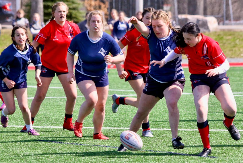 Avon View’s Amy Verge and King’s-Edgehill’s Sofia McSweeney battle to retrieve a wayward rugby ball.
